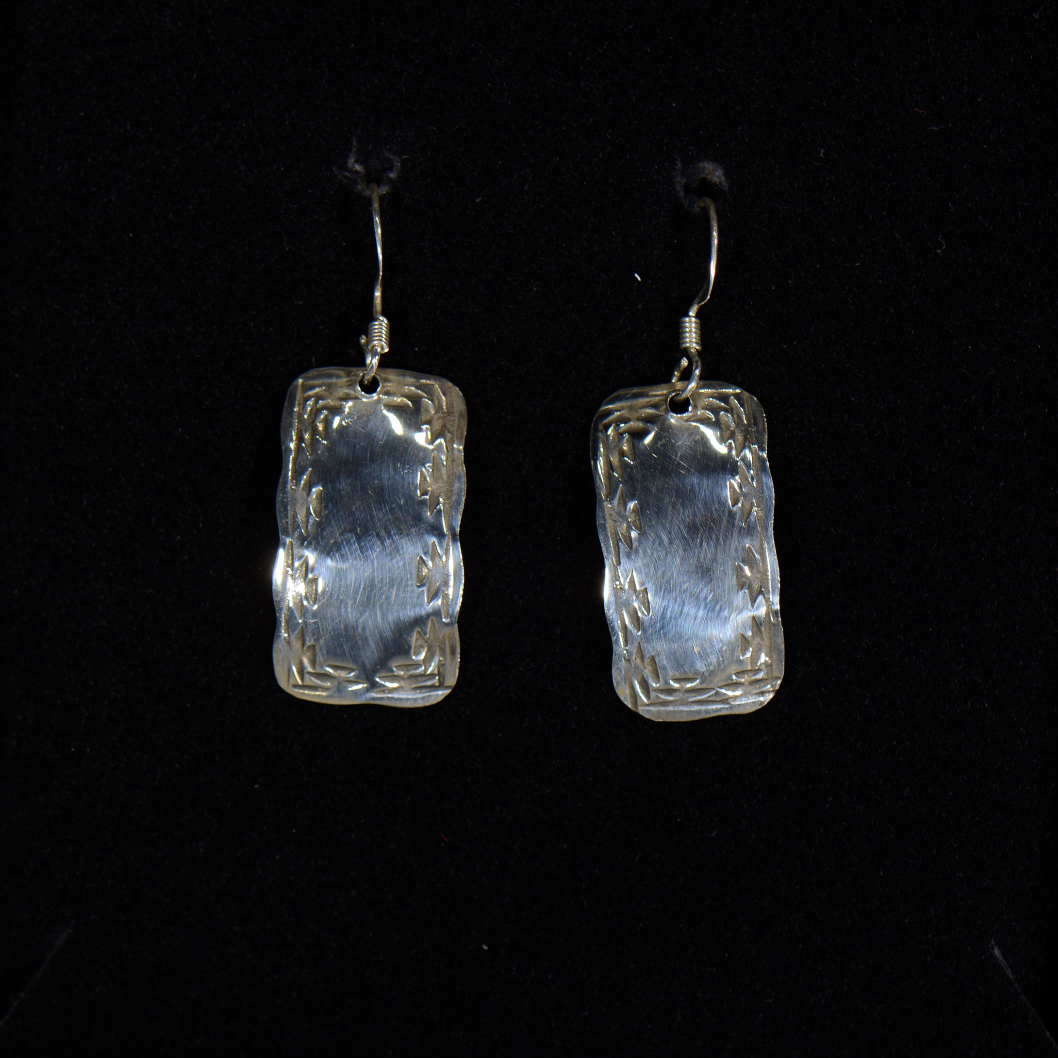 Silver earrings.